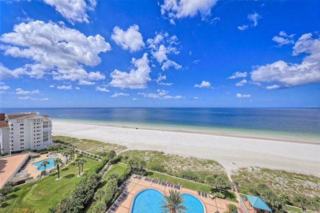 birds eye view of property featuring a water view and a beach view