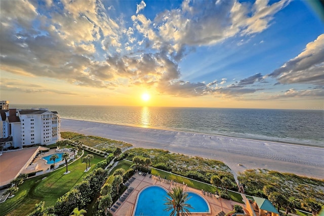 aerial view at dusk featuring a water view