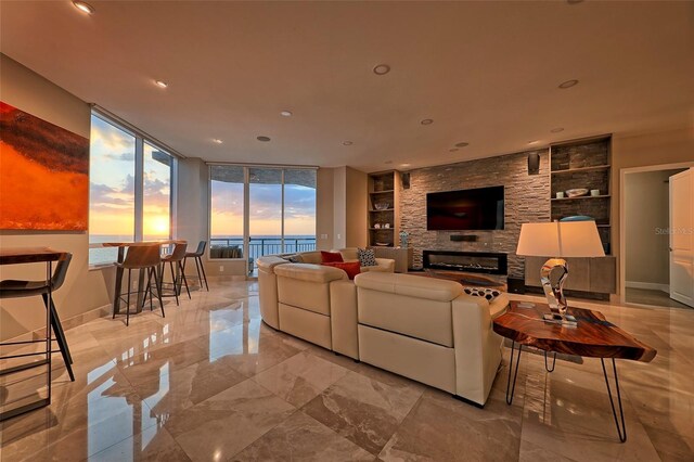 living room with a fireplace, built in shelves, and light tile patterned floors