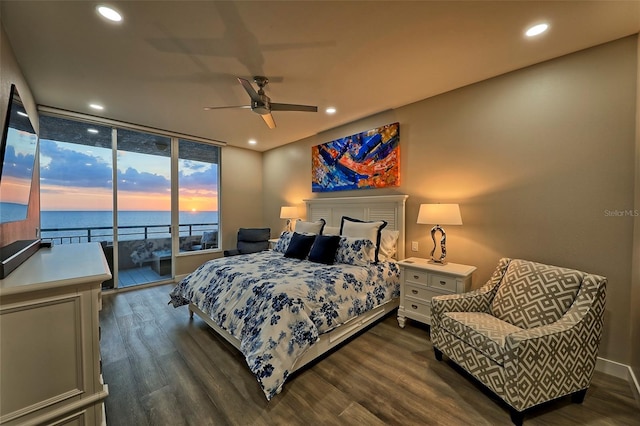 bedroom with ceiling fan, access to exterior, a water view, and dark hardwood / wood-style floors