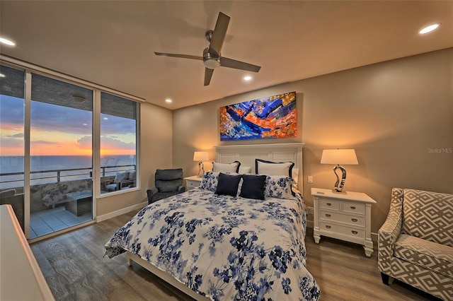 bedroom featuring hardwood / wood-style floors, a water view, access to outside, and ceiling fan