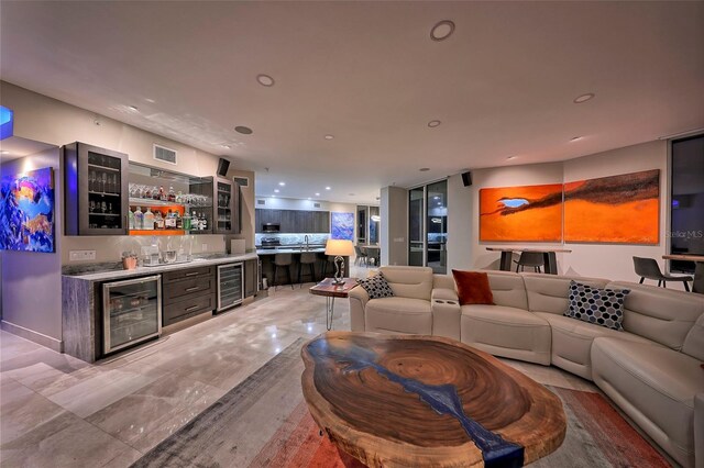 living room featuring wine cooler, sink, and tile patterned flooring