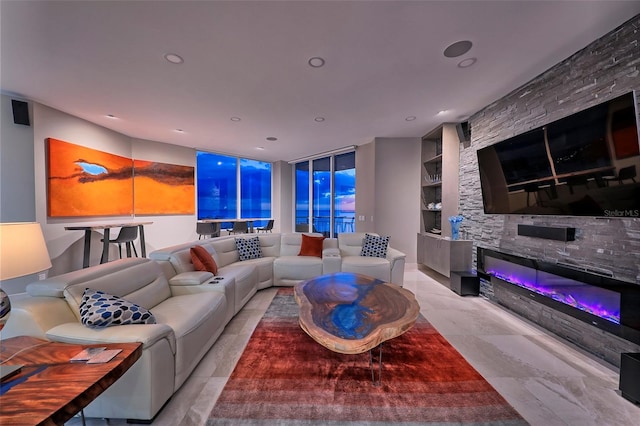 living room with built in features, a stone fireplace, and light tile patterned floors