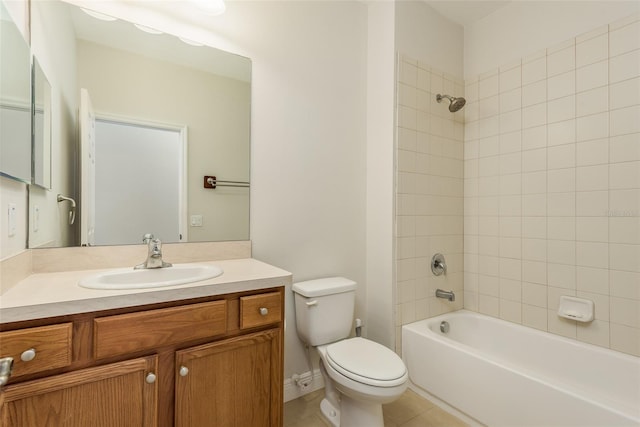 full bathroom with vanity, tiled shower / bath combo, tile patterned floors, and toilet