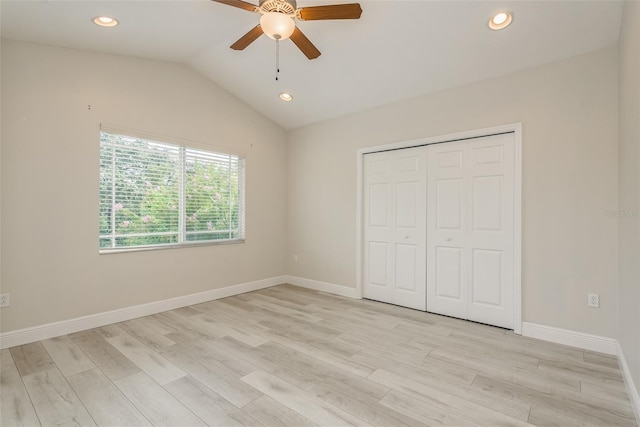 unfurnished bedroom with lofted ceiling, light hardwood / wood-style floors, a closet, and ceiling fan