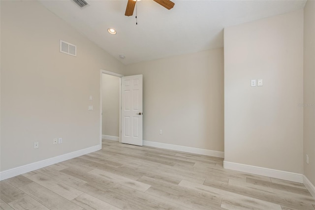 empty room with lofted ceiling, ceiling fan, and light wood-type flooring