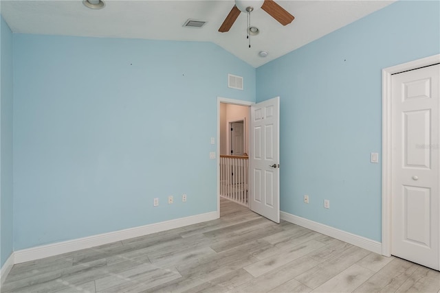 unfurnished bedroom featuring ceiling fan, lofted ceiling, and light wood-type flooring