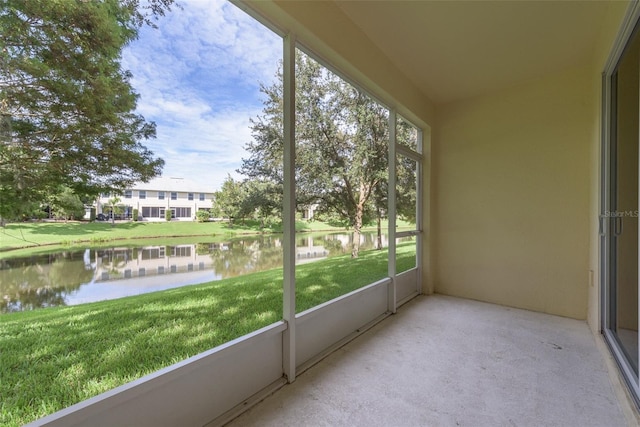 unfurnished sunroom featuring a water view