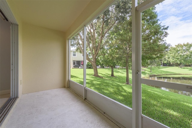 unfurnished sunroom with a water view