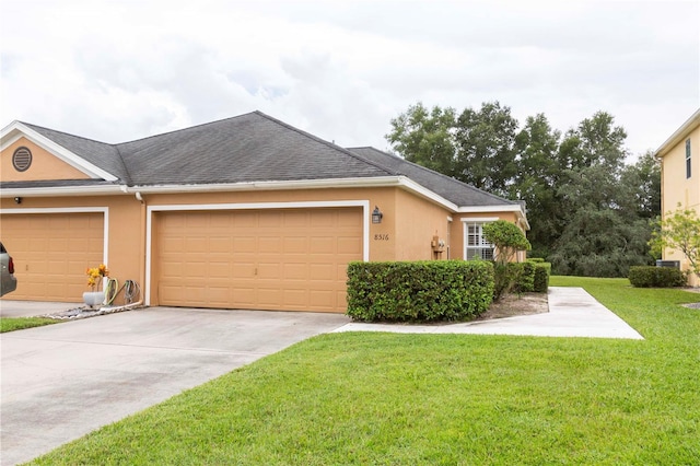 view of side of home featuring a garage and a lawn