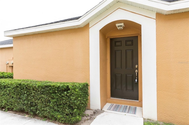 view of exterior entry with a porch