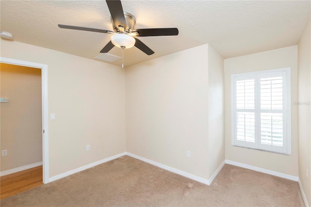 unfurnished room with ceiling fan, a wealth of natural light, and light carpet