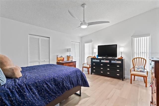 1967 Long Boat Dr, Lakeland, FL 33810 - bedroom with two closets, baseboards, a textured ceiling, ceiling fan, and wood finished floors
