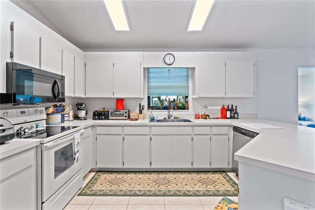 kitchen featuring white cabinets, light tile patterned floors, sink, white electric range, and stainless steel dishwasher