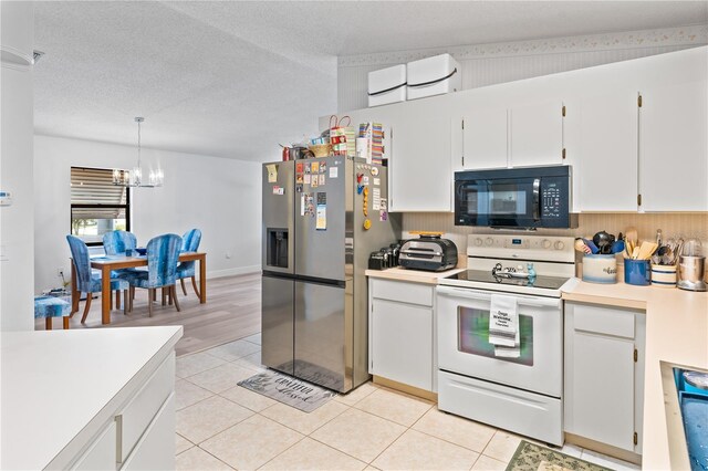 kitchen featuring stainless steel fridge with ice dispenser, a notable chandelier, white cabinetry, and electric range