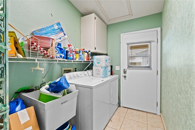 laundry room featuring separate washer and dryer, cabinets, light tile patterned floors, and sink