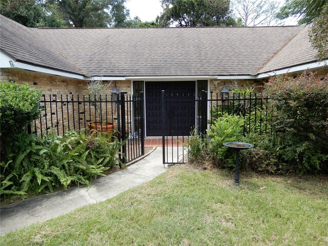 doorway to property with a yard