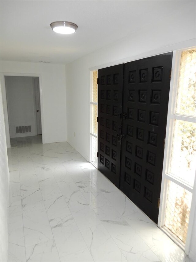 entrance foyer with plenty of natural light and tile patterned flooring