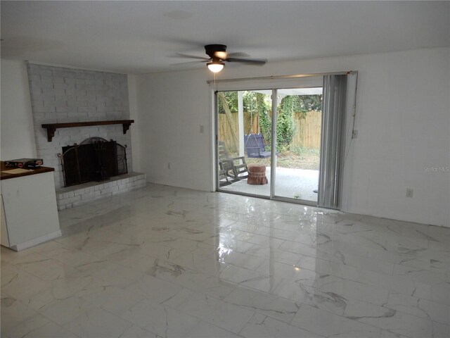 unfurnished living room featuring ceiling fan, light tile patterned flooring, a fireplace, and brick wall