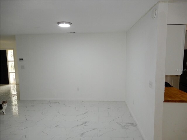 spare room with light tile patterned floors