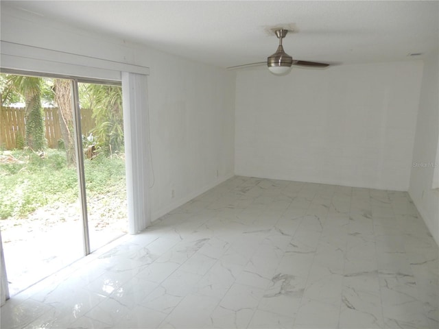 spare room featuring light tile patterned floors and ceiling fan