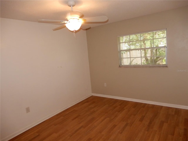 spare room featuring ceiling fan and hardwood / wood-style flooring