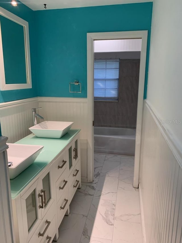 bathroom featuring bathing tub / shower combination, vanity, and tile patterned flooring