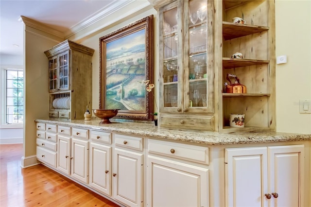 2901 Leprechaun Ln, Palm Harbor, FL 34683 - bar with baseboards, ornamental molding, and light wood-style floors