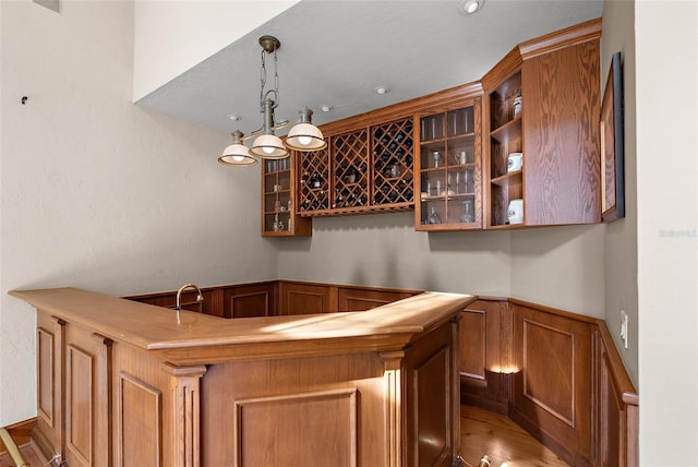 2901 Leprechaun Ln, Palm Harbor, FL 34683 - bar with indoor wet bar, wood finished floors, and hanging light fixtures