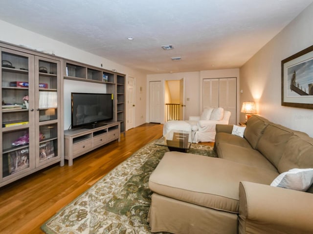 2901 Leprechaun Ln, Palm Harbor, FL 34683 - living area featuring visible vents and wood finished floors