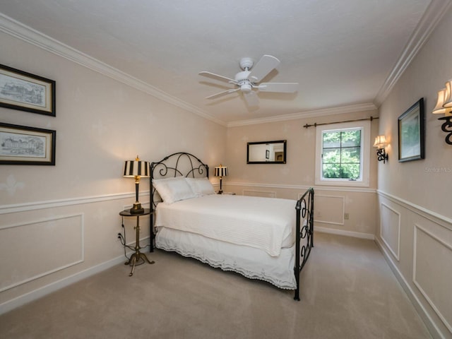 carpeted bedroom with ceiling fan and ornamental molding