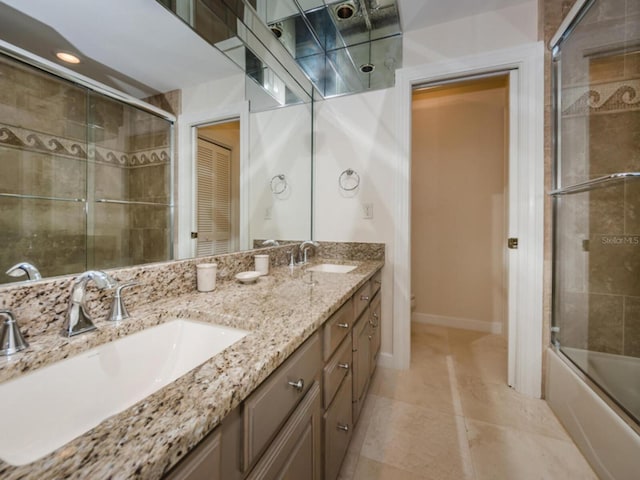 bathroom with vanity, bath / shower combo with glass door, and tile patterned flooring