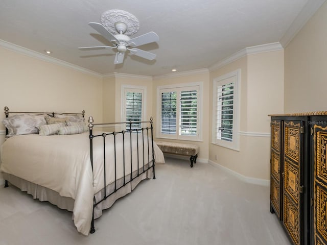 bedroom with ceiling fan, ornamental molding, and carpet floors