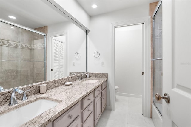 2901 Leprechaun Ln, Palm Harbor, FL 34683 - full bath with double vanity, toilet, a sink, and tile patterned flooring