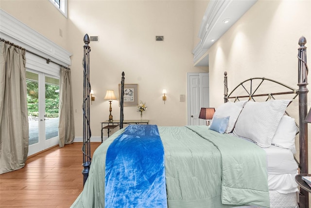 2901 Leprechaun Ln, Palm Harbor, FL 34683 - bedroom with french doors, access to outside, wood finished floors, baseboards, and a high ceiling