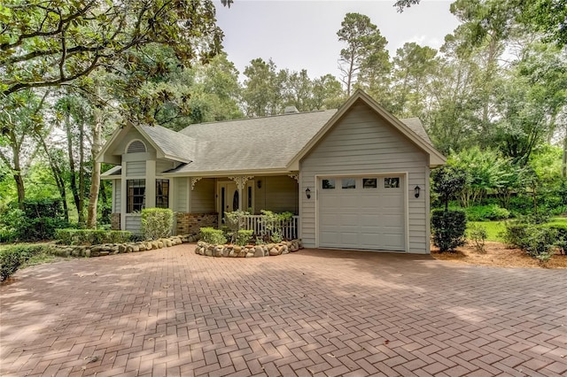 2901 Leprechaun Ln, Palm Harbor, FL 34683 - single story home featuring decorative driveway, a garage, a porch, and a shingled roof