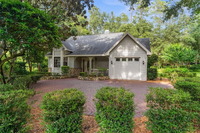 2901 Leprechaun Ln, Palm Harbor, FL 34683 - single story home featuring roof with shingles, an attached garage, a porch, and decorative driveway