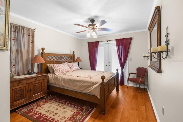 bedroom featuring french doors, ceiling fan, hardwood / wood-style flooring, and ornamental molding