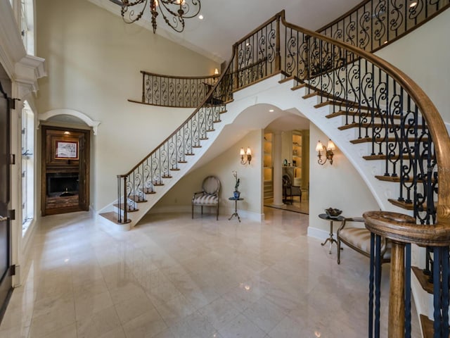 2901 Leprechaun Ln, Palm Harbor, FL 34683 - foyer entrance with stairs, a towering ceiling, a fireplace, baseboards, and arched walkways