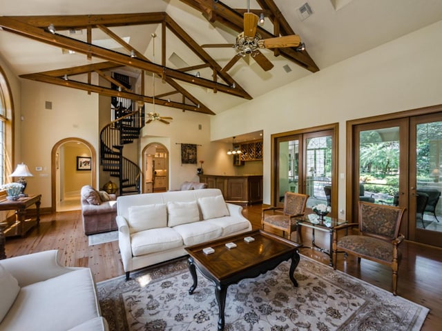 living room with a wealth of natural light, hardwood / wood-style floors, and high vaulted ceiling