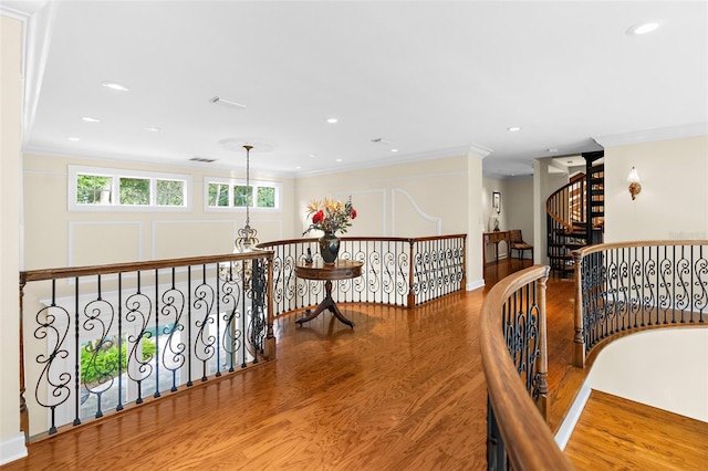 interior space with hardwood / wood-style floors, a notable chandelier, and crown molding