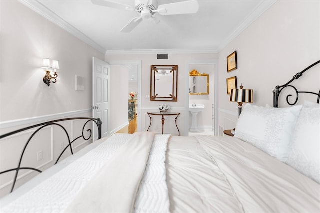 2901 Leprechaun Ln, Palm Harbor, FL 34683 - bedroom with a sink, ensuite bath, a ceiling fan, visible vents, and ornamental molding
