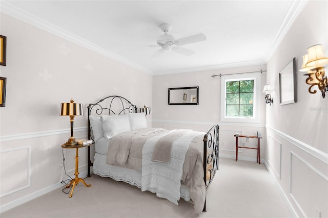 carpeted bedroom featuring ceiling fan and ornamental molding