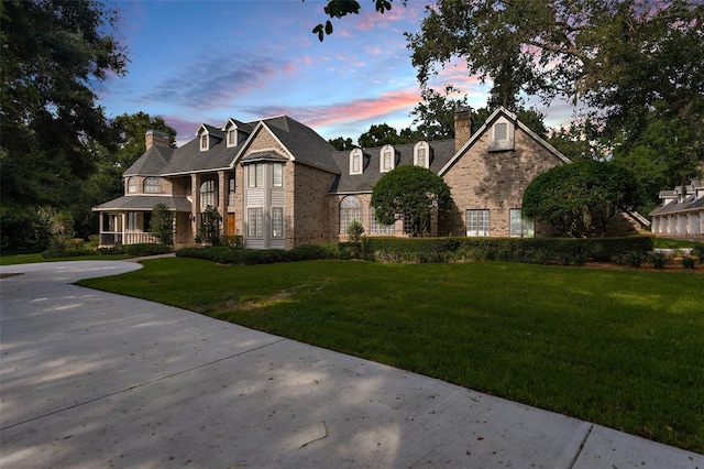 2901 Leprechaun Ln, Palm Harbor, FL 34683 - view of front of house with brick siding, stone siding, a front yard, and a chimney