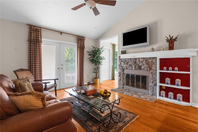 living room featuring a fireplace, vaulted ceiling, hardwood / wood-style flooring, and ceiling fan