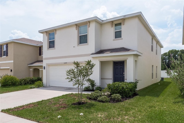 view of front of property featuring a garage and a front lawn