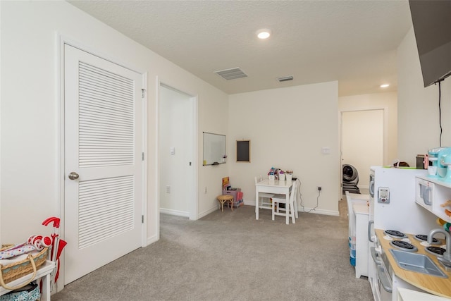 playroom featuring light colored carpet