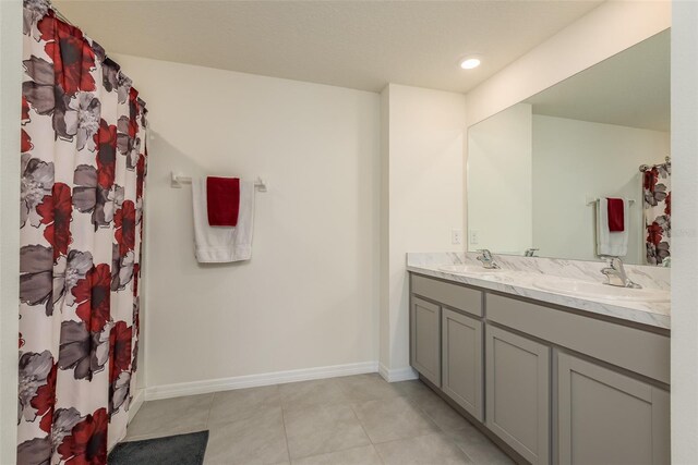 bathroom with tile patterned floors and double vanity