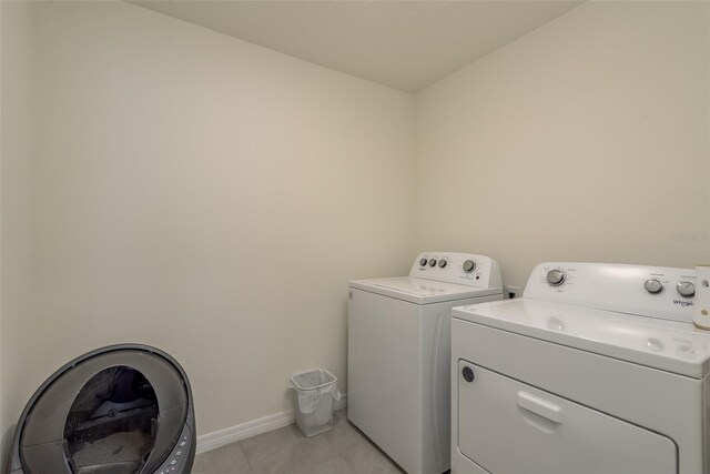 laundry area featuring light tile patterned floors and independent washer and dryer