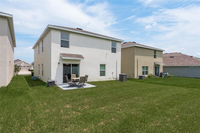 back of property featuring central air condition unit, a lawn, and a patio